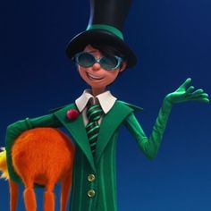 the animated character is dressed in green and has his hands out to catch an orange object