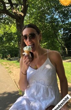 a woman is eating an ice cream sandwich