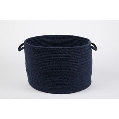 a large round basket with handles on the side, in dark blue yarn and rope