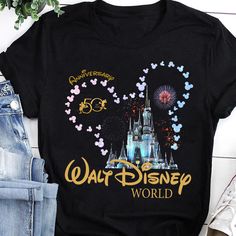 a black shirt with the words walt world on it and fireworks in the sky behind it