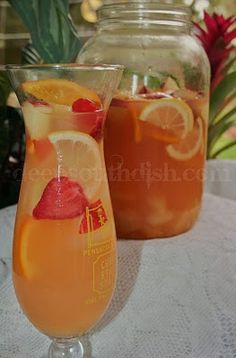 two glasses filled with drinks sitting on top of a table