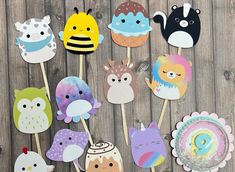 there are many animal cupcake toppers on the stick