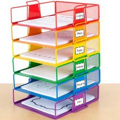 a multi - tiered desk organizer with four sections