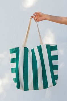 Verano is our new oversized beach bag. Made of an outdoor resistant canvas is perfect for your next sunny escapade. Not to mention the fun striped print, this bag was made for summer. Plenty of space to carry multiple towels, sunscreens, all your beach reads and more. It's lined with a light cotton canvas and comes with 2 inner pockets for your phone and wallet. It can also be customized to add a compartment for your yoga mat. Lightweight and easy to fold, toss it in your suitcase or use it as a Custom Beach Bags, Beach Reads, Basket Tote, Oversized Tote, Welcome Bags, Summer Stripes, Beach Reading, Leisure Time, Beach Bags