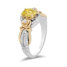 Sophisticated with a whimsical touch from the Enchanted Disney Fine Jewelry Collection, this yellow quartz and diamond ring commemorates the 30th anniversary of Disney's animated Beauty and the Beast. Fashioned in sterling silver and warm 10K gold This romantic look features a 7.0 x 5.0mm oval-shaped lemon-yellow quartz gleaming between diamond-lined silver ribbons and flanked by diamond-touched gold blooms. Along the split shank, polished gold ribbons highlight inner rows of diamonds set in silver while crown insets are the final detail. This design sparkles with 1/5 ct. t.w. of diamonds. A Certificate of Authenticity accompanies this collector's edition piece. Available in size 7 only. ©Disney Enchanted Disney, Enchanted Disney Fine Jewelry, Disney Fine Jewelry, Yellow Quartz, Platinum Jewelry, Disney Beauty And The Beast, Yellow Stone, Gold Ribbons, Lemon Quartz