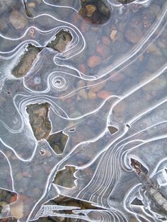 some rocks and water with small waves in it's surface, as seen from above