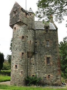 an old castle like building with stairs leading up to it's top and windows