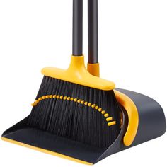 two black and yellow brooms sitting on top of each other