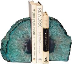 two books are stacked on top of each other in the shape of a bookend