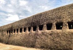 a building made out of sand with wavy shapes