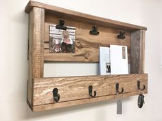 a wooden shelf with hooks on it