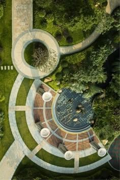 an aerial view of a circular building surrounded by greenery