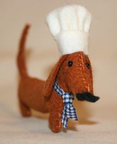 a toy dog with a chef's hat on its head