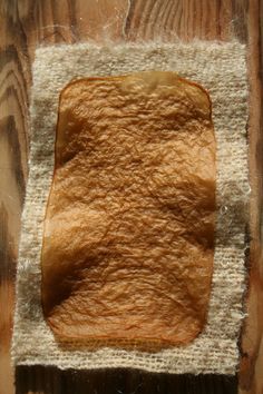 a piece of bread sitting on top of a wooden table