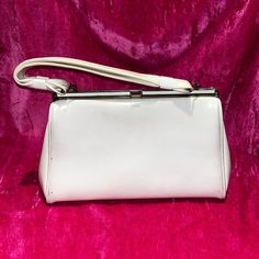 D E S C R I P T I O N This Is A 1950's White Cream Colored Patent Leather A Frame Bag With Silver Tone Hardware. M E A S U R E M E N T S Bag Width: 5” Bag Height: 7.5” Bag Length: 13” Authenticity Guarantee All Bags Sold In Our Shop Are 100% Guaranteed Authentic Or Your Money Back. Leather Frame, Leather Frames, Frame Bag, Bags Vintage, Vintage Bags, Vintage 1950s, White Cream, Hand Bag, A Frame