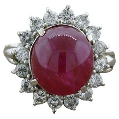 A large and impressive unheated ruby cabochon weighing 10.30 carats takes center stage. It has a rich pure red color along with great translucency making the stone appear to glow. It is complemented by a halo of round brilliant-cut diamonds weighing 1.00 carat. Hand-fabricated in platinum and ready to be worn. Ring Size 6.50 Weight: 10 grams Alexis Bittar Jewelry, Platinum Diamond Rings, Alexis Bittar, Platinum Ring, Center Stage, Round Brilliant Cut Diamond, Red Color, Fashion Rings, Heart Ring