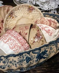 a basket filled with lots of plates on top of a table