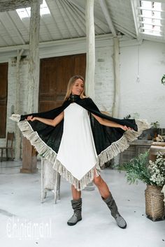 Cotton Open Back Poncho is a very original designer garment to compliment your boho outfit on a cool summer evening. High cotton canvas collar is reminiscent of elegant XIX century lady cloak, while long gorgeous linen fringe on the hemline brings an ultimate boho touch to the piece. The back of the poncho is open and also decorated with the statement fringes of our Alma Libra collection. It is made of 100% natural raw and very soft cotton. In hot climate you can wear this Poncho with our open b Black Bohemian Shawl For Fall, Hippie Shawl Poncho For Festivals, Bohemian Black Shawl For Summer, Summer Bohemian Black Shawl, Black Bohemian Poncho For Summer, Black Bohemian Poncho One Size, Black Bohemian Poncho Shawl, Bohemian Black Poncho For Fall, Bohemian Black Summer Poncho