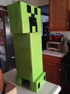 a green creeper standing on top of a counter in a kitchen next to a microwave