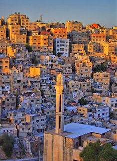 a city with lots of tall buildings and a clock tower in the middle of it