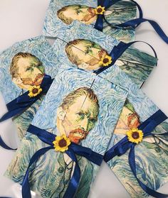 four pieces of artwork with blue ribbon around them and sunflowers in the middle