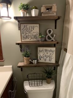 the bathroom is decorated with shelves and pictures