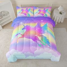 a bed room with a unicorn comforter and pillows