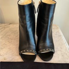 Chanel Booties Open Toe With Chain Embellishment Side Zippers Size 9 (Owner Wears An 8.5) Perfect Fit 3 5/8 " Heel Good Condition (Could Probably Use A Good Polish) Some Minor Scuffs Shown In Photos, One On Side Of One Shoe And Slight Mark On Back Of One Heel. Other Wise Overall Very Good Condition. Each Bootie Arrives To You In It's Own Chanel Dust Bag. Chanel Open Toe, Chanel Booties, Shoes Chanel, Chanel Shoes, Bootie, Side Zipper, Open Toe, Bootie Boots, Dust Bag