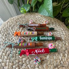 four corks with the word gumdrops on them are sitting on a wicker surface