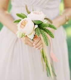 a bride holding a bouquet of flowers in her hands