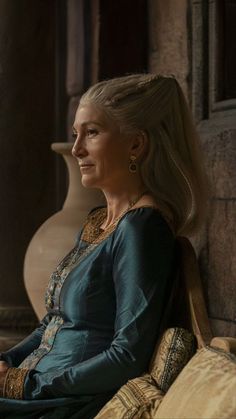 game of thrones character daeneress starke sitting on a chair looking out the window