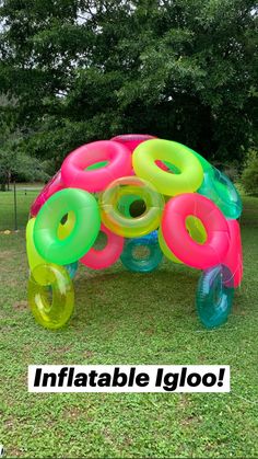 an inflatable turtle made out of many different colored donuts on the grass