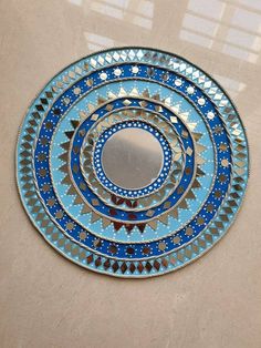 a blue and silver plate sitting on top of a table