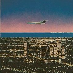 an airplane is flying over the city at night