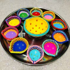 there are many colorful bowls on the plate