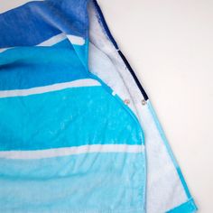 a blue and white towel laying on top of a table