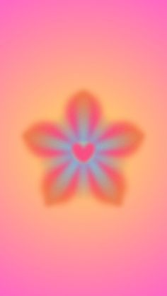 a blurry image of a flower with a heart on it's center piece