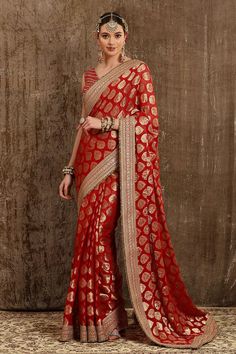 Red georgette woven saree with all ornamental booti placement pattern, border in dabka, sequence and badla work. Paired with silk chanderi V neck blouse with gota work embroidery and crystal tassels detailing on back.
Component: 2
Pattern: Embroidered and Embellished
Type Of Work: Dabka, Sequence, Badla Work and Crystal Tassels
Neckline: V Neck
Sleeve Type: Sleeveless
Fabric: Saree: Georgette, Blouse: Silk Chanderi, Lining: Taffeta Silk
Color: Red
Other Details: 
Blouse: Deep U back with hook an Kasab Embroidery, Polti Bag, Pink Saree Silk, Brocade Saree, Bridal Lehenga Designs, Paisley Motifs, Saree For Women, Half Sleeve Blouse, Embroidered Border