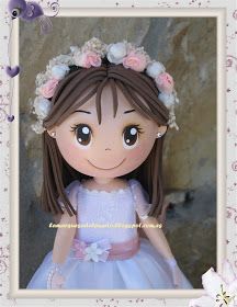 a doll with flowers in her hair wearing a dress and holding a flower headband