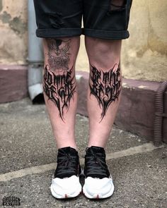 the legs and ankles of a man with black ink on his body, wearing sneakers