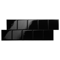 black glass tiles are stacked on top of each other in the shape of rectangles