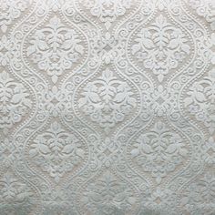 a white and grey wallpaper with an intricate design on it's side,