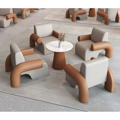 a group of chairs sitting on top of a rug next to a table with a vase