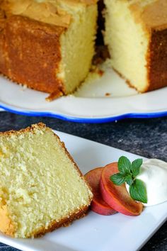 a slice of pound cake on a plate next to a sliced apple and whipped cream