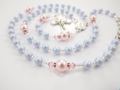 "- Personalized handmade in the USA crystal pearl rosary beads in iridescent light dreamy blue and pink - Choice of medals and personalization - Comes with a velour pouch and gift box   This light blue and pink handmade baptism rosary is made with high quality Austrian pearls and crystals, and comes personalized with a name. The colors are so subtle and sweet. Comes with your choice of Baptism, First Communion, Confirmation, or other medals. Read below for details. Over 80 colorful designs to ch Handmade Pink Rosary For Baptism, Beaded Rosary For Baptism, Handmade Rosary With Round Beads For Baptism, Square Letters, Iridescent Light, Personalized Rosary, Pearl Rosary, First Communion Gifts, Communion Gifts