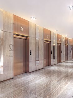 an empty room with several elevators in the wall and two doors on each side that are closed