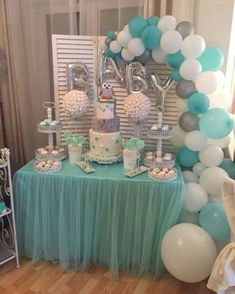 a blue and white dessert table with balloons