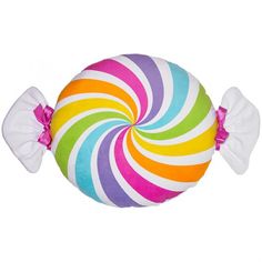 a colorful candy lollipop sitting on top of a white pillow with pink bows