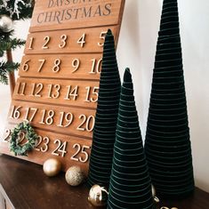 three christmas trees sitting on top of a wooden table