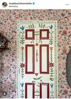 the front door is decorated with flowers and birds